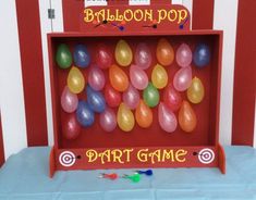 balloon pop party game in a red box with balloons on the top and an arrow pointing to it