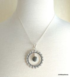 This beautiful floral solid sterling silver round pendant, with a dangling round labradorite or moonstone gemstone, is suspended on an 18 inch sterling silver 1mm cable chain. It is perfect for any occasion and is great for layering! Pendant height: 1.9 inches or 49mm, including bail Pendant width, at widest point: 1.5 inches or 38mm Dangling gemstone + silver setting diameter: 0.43 inches or 11mm Pendant setting and bail: sterling silver Convo me for a different length chain (additional charges Silver Labradorite Teardrop Pendant Jewelry, Bohemian Style Jewelry With Round Pearl Pendant, Bohemian Style Round Pearl Pendant, Silver Labradorite Round Pendant Necklace, Bohemian Jewelry With Round Pearl Pendant, Sterling Silver Natural Stones Flower Pendant Jewelry, Sterling Silver Jewelry With Natural Stones Flower Pendant, Sterling Silver Necklace With Gemstone Beads And Round Pendant, Sterling Silver Flower Pendant With Natural Stones