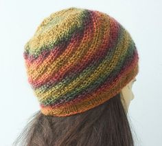 a woman's head wearing a multicolored knitted hat