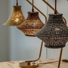 three lamps that are hanging from the ceiling