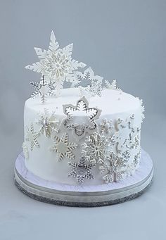 a white frosted cake with snowflakes on top