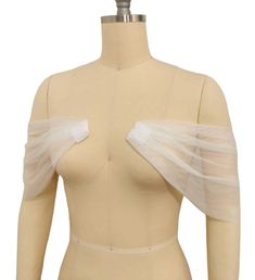 a mannequin torso with white tulle on it's arms and shoulder