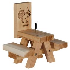 a wooden toy bench with a squirrel on it