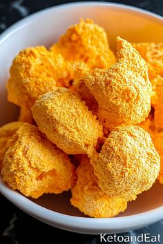 a white bowl filled with fried food on top of a table