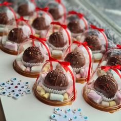 chocolate candies are wrapped in red ribbon and placed on a table