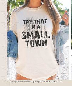 Looking for a country music shirt that shows your pride in being from a small town? Look no further than our try that in a small town t shirt! This Team Aldean shirt features the lyrics to Aldean's song "try that in a small town" and is perfect for showing your support for the country music star. Made with 100% cotton, this shirt is comfortable and will make you feel like a proud American! Grab a shirt today and show everyone that you're loyal to your hometown! *Fashionably vintage, lived-in, an Fall Letter Print T-shirt For Country Concerts, Graphic Tee With Letter Print For Country Festivals, Cotton T-shirt With Letter Print For Country Festivals, Cotton Graphic Print Tops For Country Festivals, Graphic Print Crew Neck Tops For Country Festivals, Cotton Tops For Country Concerts And Festivals, Crew Neck T-shirt For Country Concerts And Festivals, Crew Neck T-shirt For Country Concerts, Relaxed Cotton T-shirt For Country Festivals