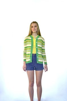 70s Retro Sweater + Yellow | Bright Green | White Colored Stripes of Varying Thickness + Contrasting Green Collar and Button Placket + Long Sleeve + Lightweight Fabric + Buttons up Front + Collarless + Crew Neck + Straight Hem + Excellent Vintage Condition + Will Best Fit Sizes xxs–s Specifics |||(Some stretch)Bust - 18.5”Waist - 16.25”Shoulders - 15.25”Sleeves - 22.25”Hips - 17” (width at hem)Length - 24.25”Size - Marked Size | Estimated Size xxs–sColor - Green | Yellow | White Label - GeistexF Retro Fitted Button-up Cardigan, Fitted Button-up Retro Cardigan, Summer Retro Long Sleeve Cardigan, Retro Button-up Cardigan, Vintage Green Cardigan With Button Closure, Vintage Green Cardigan For Spring, Vintage Spring Cardigan With Button Closure, Vintage Green Spring Cardigan, Retro Cotton Cardigan With Button Closure