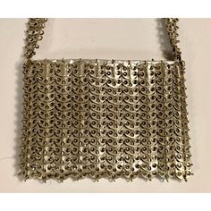 French designer Paco Rabanne is best known for his revolutionary 1968 dresses made from metal discs and rings. This rare handbag soon followed, made from the same materials. The bag has a shoulder strap, an interior silver leather pouch which has a metal zipper, a fabric lining, and the Paco Rabanne label.  It is in excellent condition, with very minor loss to the finish on three of the discs making up the shoulder strap. Measurements; Length 9"  Height 6"  Depth 1.5" Modern Metal Bags For Formal Occasions, Silver Metal Rectangular Shoulder Bag, Silver Rectangular Metal Shoulder Bag, Rectangular Silver Metal Shoulder Bag, Elegant Silver Bag With Chainmail Detail, Silver Metal Chainmail Bag, Elegant Silver Chainmail Bag, Silver Chainmail Bag For Everyday Use, Elegant Evening Shoulder Bag With Chainmail