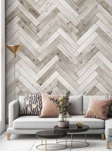 a living room with wood wallpaper and white couches, coffee table and lamp