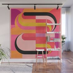 an abstract wall mural in pink, yellow and orange with black lines on the side