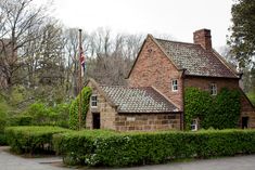 an old brick house with ivy growing around it