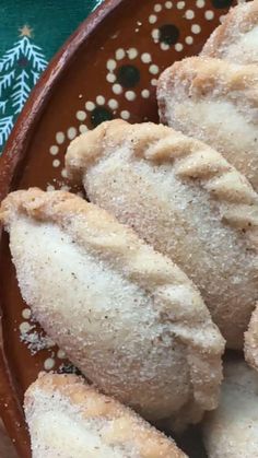 powdered sugar donuts on a brown plate