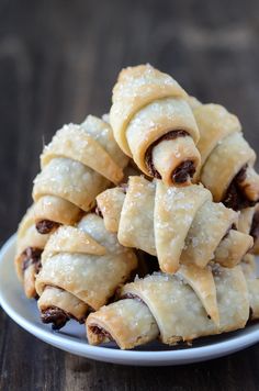 a white plate topped with pastries on top of a wooden table