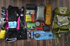 an assortment of items laid out on the floor to be packed up for hikes