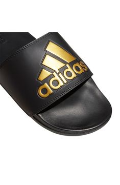 Versatile and comfortable, this bandage-style slide cushioned with a contoured footbed is perfect for laid-back days. Open toe Slip-on style Synthetic upper/textile lining/synthetic sole Imported Adidas Comfortable Flip Flops With Cushioned Footbed, Adidas Sandals With Cushioned Footbed, Comfortable Adidas Cushioned Flip Flops, Comfortable Adidas Slides With Synthetic Material, Adidas Slides With Cushioned Footbed For Beach, Black Sandals With Textured Footbed, Adidas Synthetic Flip Flops For Sports, Black Sandals With Arch Support For Swimming, Synthetic Slides With Removable Insole For Swimming