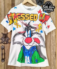 #Tweety #Sylvester #cartoon #cartoontee #looneytunes #tee #tshirt #streetwear #vintagereprint #y2k #shopvintage #thrift #thriftshop #90sstyle #vintageclothing #vintaget #bootleg #alloverprint #aop Vintage Cotton T-shirt With All Over Print, Cotton Sublimation Streetwear With Printed Design, Cotton Sublimation Printed Streetwear, Vintage All Over Print T-shirt For Streetwear, Vintage All-over Print T-shirt For Streetwear, Pop Culture Sublimation Graphic Crew Neck, Pop Culture Sublimation Crew Neck T-shirt With Graphic Print, Graphic Tee With Character Print And Crew Neck, White Cotton T-shirt With Cartoon Sublimation Design