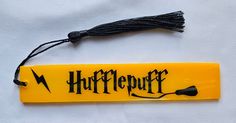 a yellow harry potter bookmark with a black tassel