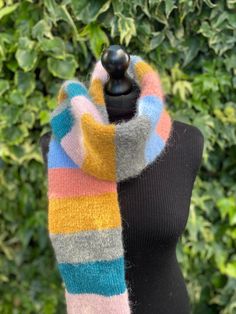 Hand knitted brushed alpaca and wool tube scarf in grey, blues, pinks and mustard. This tube scarf is double sided showing only the right side of the knit.  Ideal for colder months as this scarf is very thick and will keep you very warm. Very fluffy, soft and light. All my scarves are hand knitted by myself in Wales, UK, using sustainable natural fibers.  Wrapped and supplied with non plastic materials. Measurements: Scarf is shown on dummy size 8 (UK size). Length: 160 cm Width: 12 cm Weight: 1 Thick Scarf, Wales Uk, Tube Scarf, Striped Scarves, Double Face, Winter Scarf, Natural Fibers, Scarf Wrap, Alpaca