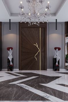 an elegant lobby with chandelier, marble floors and artwork on the wall behind it