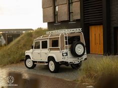 a white jeep parked in front of a building