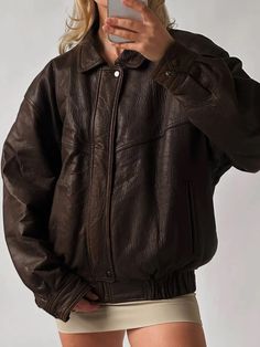 Embrace the spirit of the '90s with this oversized vintage dark brown genuine leather bomber jacket. Made from luxurious leather, this piece boasts a soft, supple feel that elevates any outfit. The oversized silhouette offers a relaxed, laid-back vibe, making it perfect for layering over your favorite tees or sweaters. With its classic bomber design, this jacket combines comfort and style effortlessly. The rich dark brown hue adds a touch of sophistication, while the subtle sheen from the waxed finish gives it a unique character. Functional pockets provide practicality without sacrificing style, making it a versatile staple for any wardrobe. Whether you're heading out for a casual day or dressing up for a night on the town, this vintage bomber jacket is the perfect blend of nostalgia and c Chic Outerwear, Womens Biker Jacket, Straight Jacket, Casual Wear Women, Real Leather Jacket, Genuine Leather Jackets, Brown Leather Jacket, Leather Jackets Women, Looks Vintage