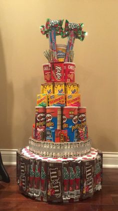 a cake made to look like a stack of cans with candy on top and candies in the middle