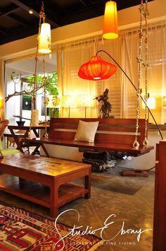 a living room filled with furniture and hanging lights