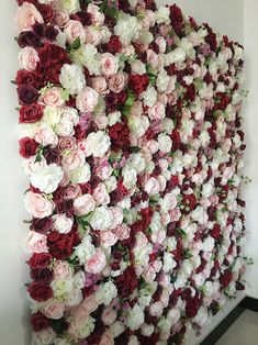 a wall made out of flowers and greenery