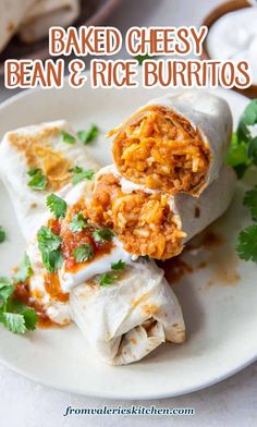 baked cheesy bean and rice burritos on a plate with cilantro