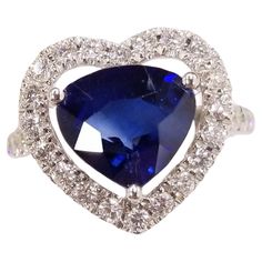 Introducing a magnificent piece of jewelry, this IGI certified ring is a true epitome of elegance and beauty. Crafted in 18K white gold, it features a stunning 3.15 carat intense blue sapphire in a captivating pear shape at its center. The intense blue hue of the sapphire exudes sophistication and adds a touch of regality to the design. Surrounding the pear-shaped sapphire is a mesmerizing halo of 0.67 carat round diamonds. These sparkling diamonds are precisely set to enhance the brilliance of Blue Sapphire Diamond Ring, Sapphire And Diamond Ring, Blue Sapphire Diamond, Everyday Accessories, Brilliant Diamond, Love Symbols, Sparkle Diamonds, Pear Shape, White Gold Rings