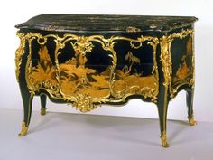 an ornate black and gold painted chest with figures on it's sideboard, in the style of louis ii