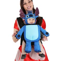 a woman holding a baby in a costume