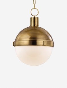 a brass colored light hanging from a chain