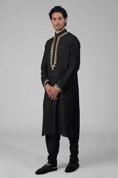 Black kurta featuring intricate tilla embroidery and delicate gold silk thread work on the front placket, sleeves, and neckline. Paired with a pathani salwar.
Components: 2
Pattern: Embroidered
Type Of Work: Tilla
Neckline: Band collar
Sleeve Type: Long
Fabric: Silk
Color: Black
Other Details: 
Attached lining
Length:
Kurta: 47 inches
Sleeve: 27 inches
Placket: 15.5 inches
Salwar: 42 inches
Occasion: Sangeet - Aza Fashions Pathani Salwar, Tilla Embroidery, Black Kurta, Gold Silk, Band Collar, Fabric Silk, Thread Work, Silk Thread, Embroidered Silk