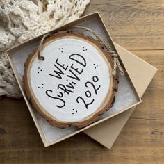 a wooden slice with the words we wed served on it is in a gift box