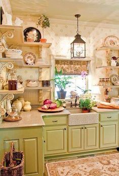 a kitchen with green cabinets and shelves filled with dishes on top of each countertop