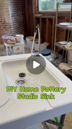 a white sink sitting inside of a kitchen next to a brick wall with the words diy home pottery studio sink