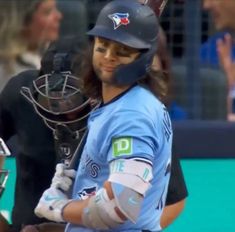 a baseball player holding a catchers mitt on top of a field