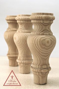 three wooden vases sitting on top of a table