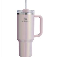 the tumbler cup has a straw in it and is light pink with silver trim