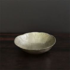 a white bowl sitting on top of a wooden table