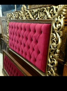 an ornate gold and red bed frame