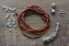 the beads and leather cord are laid out on the table