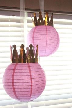 two pink paper lanterns hanging from a window with the words sofia the first birthday party ideas