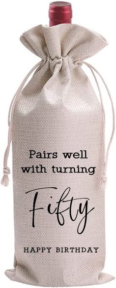 a white bag with the words, paris well with turning fifty happy birthday on it