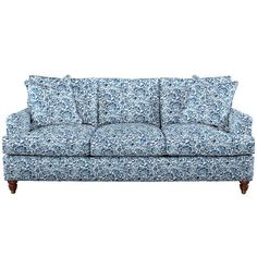 a blue and white floral couch with pillows on it's back end, against a white background