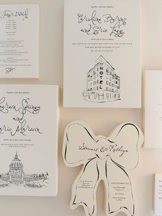 the wedding stationery is laid out on top of each other, including an envelope with a bow