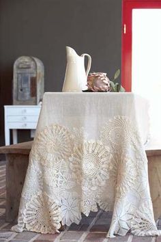 an image of a table cloth with flowers on it and a tea pot next to it