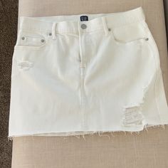 Size 29 White Jean Miniskirt. Distressed With Frayed Hem. Never Worn Fitted Cutoff White Mini Skirt, Gap Casual Cotton Skirt, Casual Cotton Skirt By Gap, Fitted White Cutoff Mini Skirt, White Mid-rise Denim Skirt, Gap Cotton Summer Skirt, Gap Casual Fitted Mini Skirt, Gap Cotton Skirt For Summer, Summer Cotton Skirt By Gap