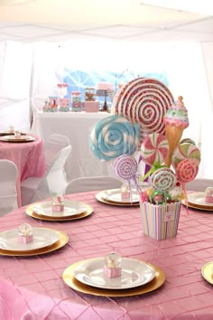 a table set up with candy and lollipops